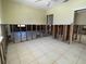 Partially renovated living room with tile flooring and open doorway, ready for your personalized design at 3207 S De Bazan Ave, St Pete Beach, FL 33706