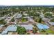 An aerial view of the neighborhood showcasing lush greenery, community pool, and nearby homes at 323 48Th Nw St, Bradenton, FL 34209