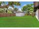 Well manicured backyard featuring a large grassy area and storage shed at 323 48Th Nw St, Bradenton, FL 34209