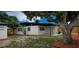 Spacious backyard features a patio area and mature shade trees offering a tranquil outdoor space at 323 48Th Nw St, Bradenton, FL 34209