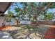 A spacious backyard with a large shade tree and a storage shed at 323 48Th Nw St, Bradenton, FL 34209