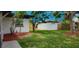 View of a backyard featuring a storage shed, freshly laid mulch, and green grass at 323 48Th Nw St, Bradenton, FL 34209