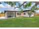 A charming backyard featuring a screened-in porch and lush green lawn at 323 48Th Nw St, Bradenton, FL 34209