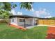 A beautifully landscaped backyard featuring a well-manicured lawn, patio, and privacy fence at 323 48Th Nw St, Bradenton, FL 34209
