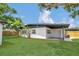 The backyard features a well manicured lawn and freshly painted exterior of the home at 323 48Th Nw St, Bradenton, FL 34209