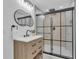 Contemporary bathroom featuring a sleek shower, floating vanity, and a round mirror at 323 48Th Nw St, Bradenton, FL 34209