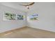 Airy bedroom featuring a ceiling fan and two windows offering views and ample natural light at 323 48Th Nw St, Bradenton, FL 34209