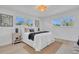 Bright bedroom with a white comforter, jute rug, and contemporary accents at 323 48Th Nw St, Bradenton, FL 34209