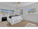 Bright bedroom with white bedding, a ceiling fan, and large windows at 323 48Th Nw St, Bradenton, FL 34209