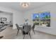 Cozy dining area with modern table set and view of palm trees at 323 48Th Nw St, Bradenton, FL 34209
