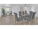 Spacious dining room features a glass table with six chairs and ample natural light at 323 48Th Nw St, Bradenton, FL 34209