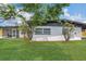 Charming home exterior with well-manicured lawn and lush greenery for a welcoming curb appeal at 323 48Th Nw St, Bradenton, FL 34209
