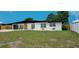 Single-story home boasts a sleek black roof, freshly painted white exterior, and newly installed front yard at 323 48Th Nw St, Bradenton, FL 34209