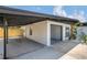 The home's exterior featuring a carport, open garage, manicured landscaping, and large windows at 323 48Th Nw St, Bradenton, FL 34209