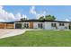 Charming single-story home boasting a manicured lawn and modern architectural details at 323 48Th Nw St, Bradenton, FL 34209