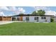 Beautiful modern home featuring a well manicured lawn and a carport at 323 48Th Nw St, Bradenton, FL 34209