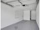A freshly painted interior featuring an open garage with large windows and sealed concrete flooring at 323 48Th Nw St, Bradenton, FL 34209