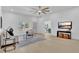 Sunlit living room with hardwood floors, a view to the dining area, and modern decor at 323 48Th Nw St, Bradenton, FL 34209