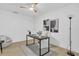 Well-lit home office with a desk and white accent chair at 323 48Th Nw St, Bradenton, FL 34209