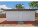 Charming shed featuring painted white wood and located in a beautifully landscaped backyard at 323 48Th Nw St, Bradenton, FL 34209