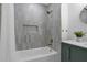 Modern bathroom with a gray tiled shower and gold hardware, blending style with functionality at 323 48Th Nw St, Bradenton, FL 34209