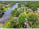 Aerial shot showcasing a home situated on a waterway, nestled among lush trees and foliage at 3366 Clover Leaf Ln, Land O Lakes, FL 34639