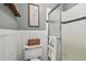 Bathroom featuring a toilet, shower with glass doors, and a decorative shelf at 3366 Clover Leaf Ln, Land O Lakes, FL 34639