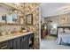 Beautiful bathroom with wallpaper, mirror, sink, vanity, and bedroom view at 3366 Clover Leaf Ln, Land O Lakes, FL 34639