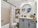 Bathroom featuring a tub, shower, vanity, and round mirror at 3366 Clover Leaf Ln, Land O Lakes, FL 34639