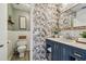 Beautiful bathroom with wallpaper, mirror, sink, vanity, and toilet at 3366 Clover Leaf Ln, Land O Lakes, FL 34639
