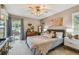 Calm bedroom with light grey walls, stylish decor, and a sliding door that provides access to the outside patio at 3366 Clover Leaf Ln, Land O Lakes, FL 34639