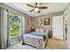 Bright bedroom with a ceiling fan, view of the backyard, and a closet at 3366 Clover Leaf Ln, Land O Lakes, FL 34639