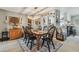 Inviting dining room featuring a stylish light fixture, seating for six, and views of the adjacent kitchen at 3366 Clover Leaf Ln, Land O Lakes, FL 34639