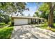Charming single-story home with a two-car garage, manicured lawn, and welcoming curb appeal at 3366 Clover Leaf Ln, Land O Lakes, FL 34639