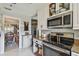 Modern kitchen with stainless steel appliances, granite countertops, and convenient access to the dining area at 3366 Clover Leaf Ln, Land O Lakes, FL 34639