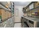Laundry room with updated washer and dryer, overhead shelving and decorative wallpaper at 3366 Clover Leaf Ln, Land O Lakes, FL 34639
