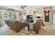 Cozy living room with comfortable seating, a ceiling fan, and a sliding glass door leading to the backyard at 3366 Clover Leaf Ln, Land O Lakes, FL 34639