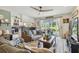 Inviting living room is adjacent to the kitchen and features comfortable seating and access to the outdoor patio at 3366 Clover Leaf Ln, Land O Lakes, FL 34639