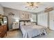 Comfortable main bedroom featuring a ceiling fan, closet, and decor at 3366 Clover Leaf Ln, Land O Lakes, FL 34639
