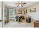 Home office with a ceiling fan, desk, and natural light from the window at 3366 Clover Leaf Ln, Land O Lakes, FL 34639