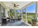 Screened patio with furniture and beautiful backyard lake view at 3366 Clover Leaf Ln, Land O Lakes, FL 34639