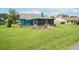 A spacious backyard featuring a screened-in porch and well-manicured lawn, offering ample space for outdoor activities at 34507 Cedarfield Dr, Dade City, FL 33523
