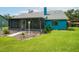 A spacious backyard features a screened-in porch and lush landscaping, ideal for outdoor relaxation and entertaining at 34507 Cedarfield Dr, Dade City, FL 33523