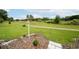 A lush backyard with a birdhouse and expansive green space beyond, perfect for enjoying nature and outdoor activities at 34507 Cedarfield Dr, Dade City, FL 33523