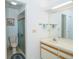 Bathroom featuring a large mirror, vanity, and walk-in shower at 34507 Cedarfield Dr, Dade City, FL 33523