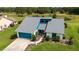 An aerial view of a charming home showcasing a well-manicured lawn and tasteful landscaping in a peaceful neighborhood at 34507 Cedarfield Dr, Dade City, FL 33523