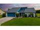 Charming single-Gathering home features a well-maintained lawn, tasteful landscaping, and a vibrant blue garage door at 34507 Cedarfield Dr, Dade City, FL 33523
