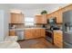 Well-lit kitchen with wood cabinets, stainless steel appliances, and tile backsplash at 34507 Cedarfield Dr, Dade City, FL 33523