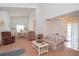 Spacious living room with plush carpeting, vaulted ceiling, and natural light from a dining area at 34507 Cedarfield Dr, Dade City, FL 33523