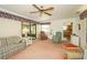 Inviting living room with sliding glass doors and comfortable seating, adjacent to a view of the kitchen at 34507 Cedarfield Dr, Dade City, FL 33523